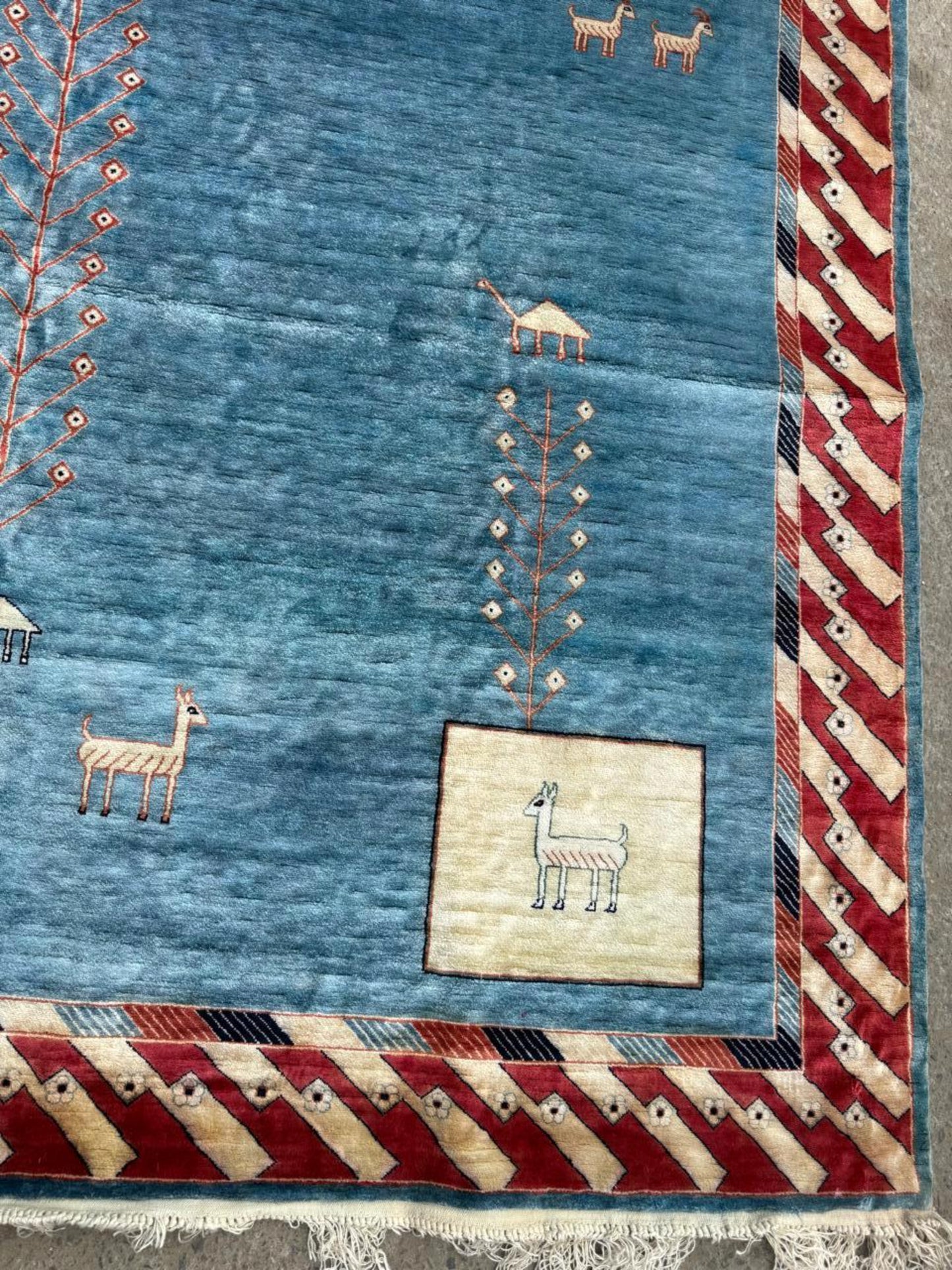 Close-up of the contrasting charcoal grey geometric motifs against the light background.

