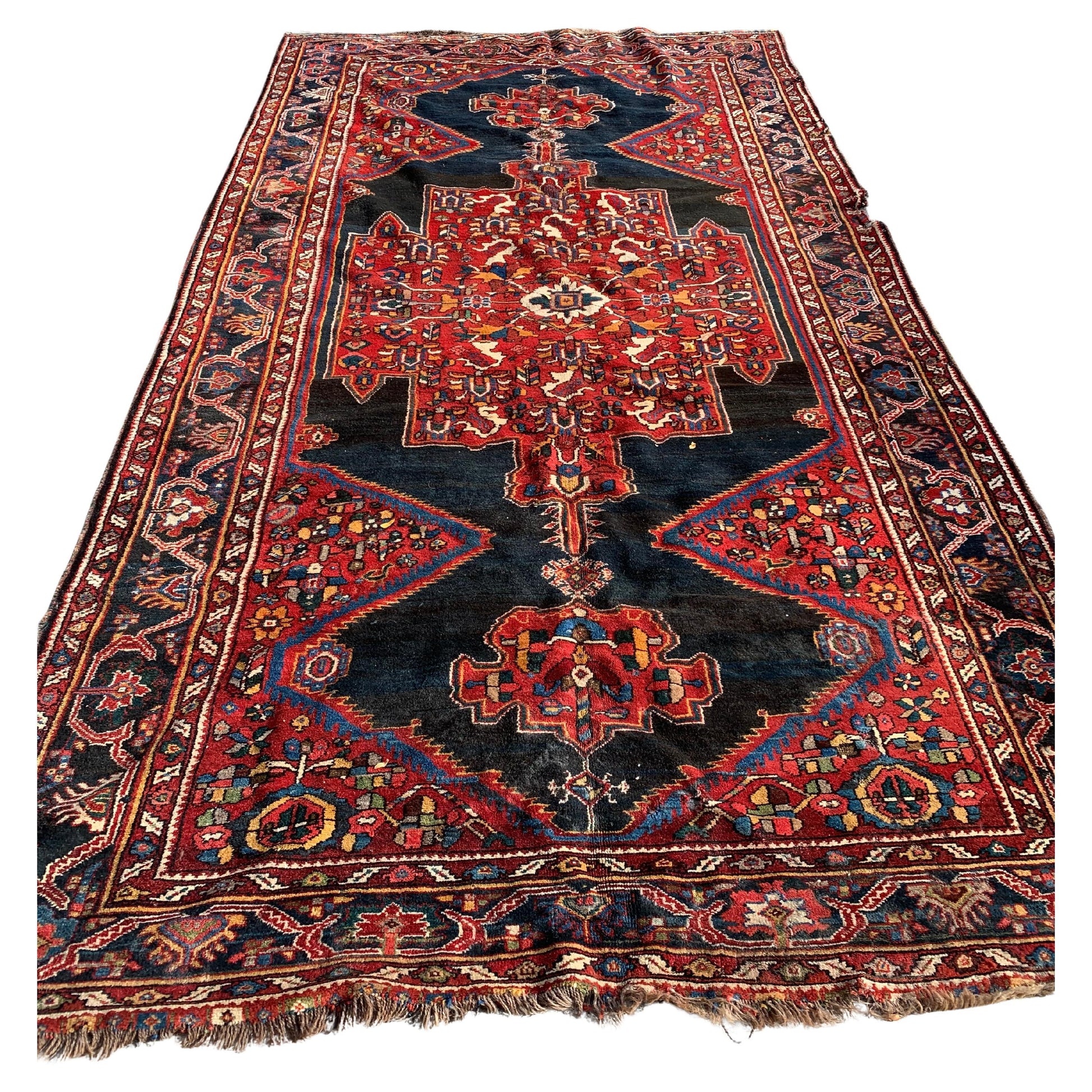 Handmade antique Persian Luri rug with vibrant geometric patterns.
