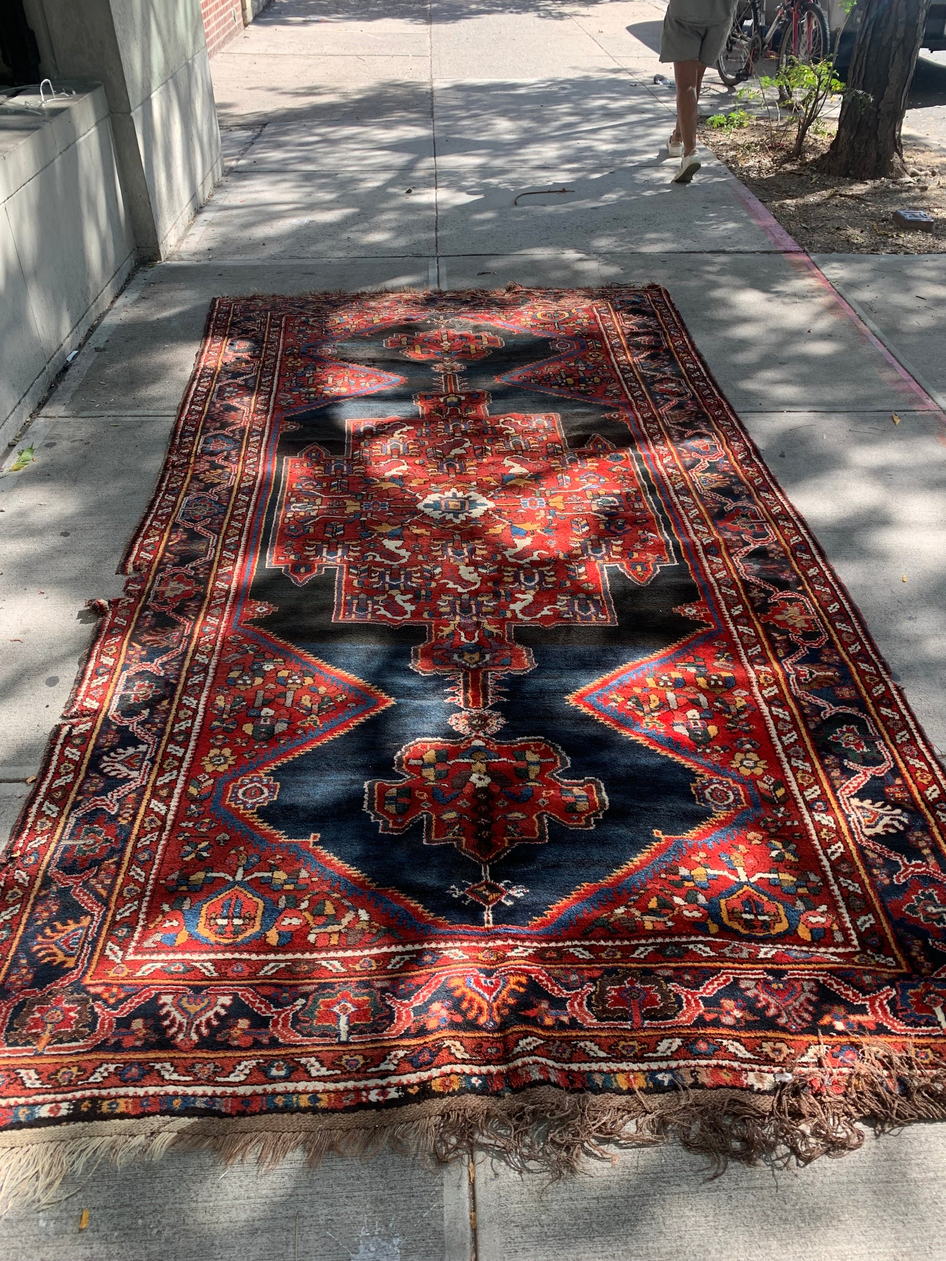 1880s Persian Luri rug with deep red and navy tones.
