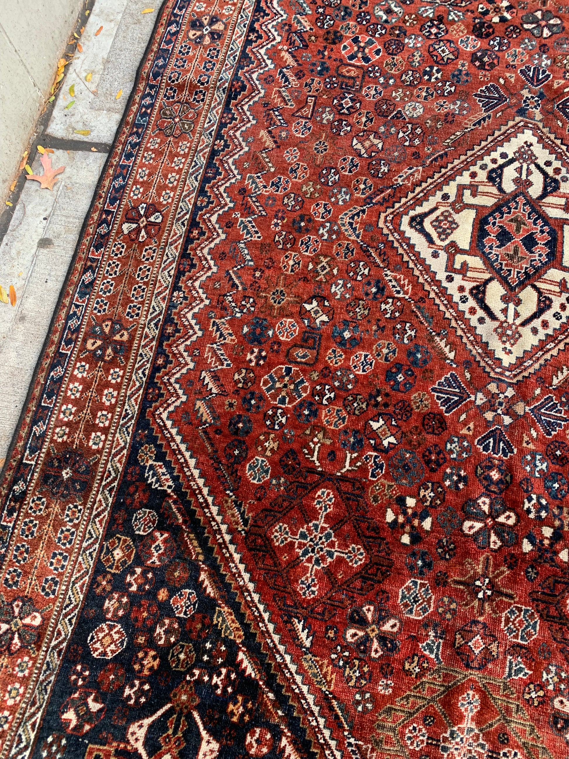 Early 1900s Persian rug showcasing nomadic craftsmanship.
