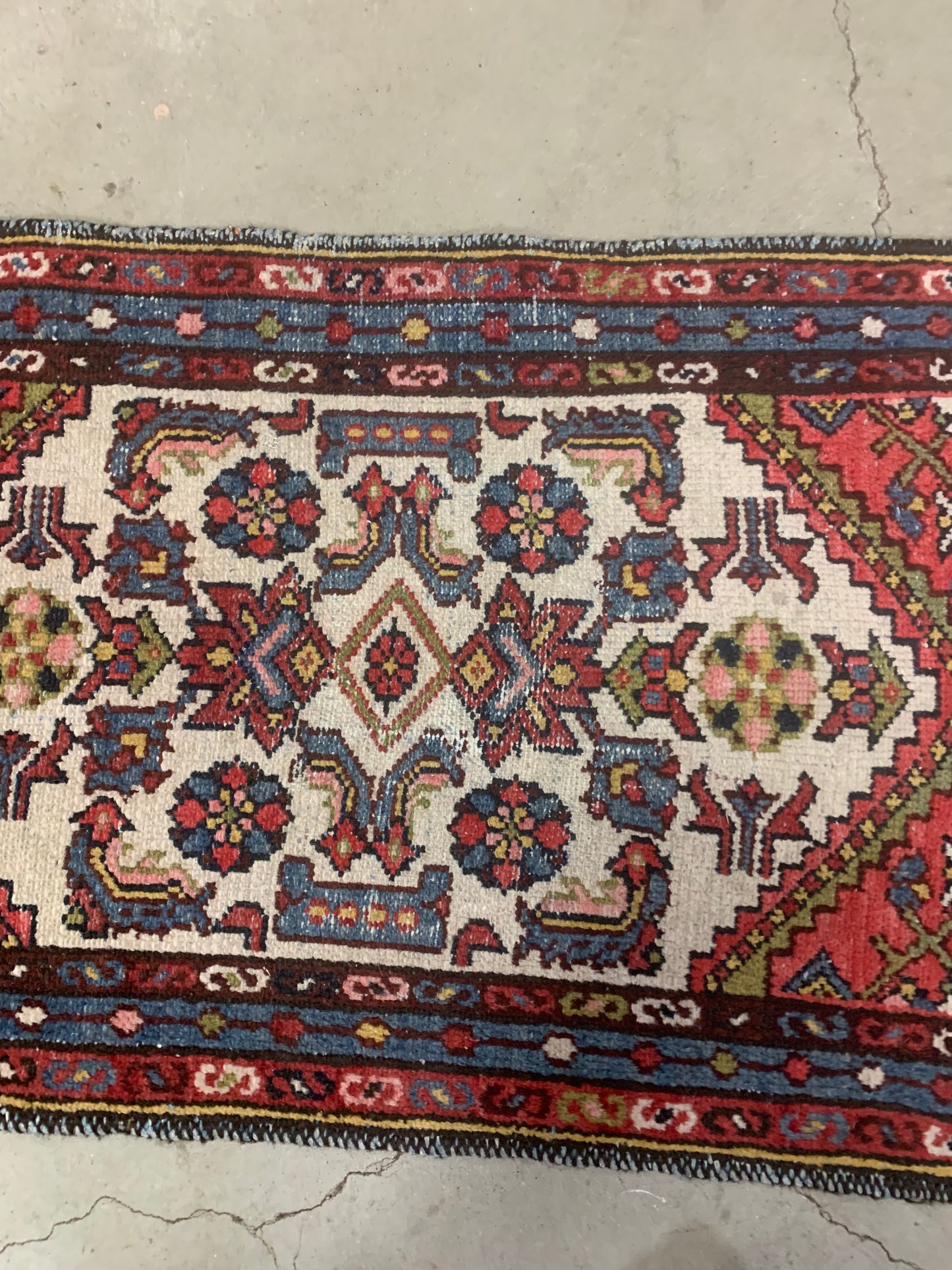 Symmetric central medallion on an antique Persian rug.
