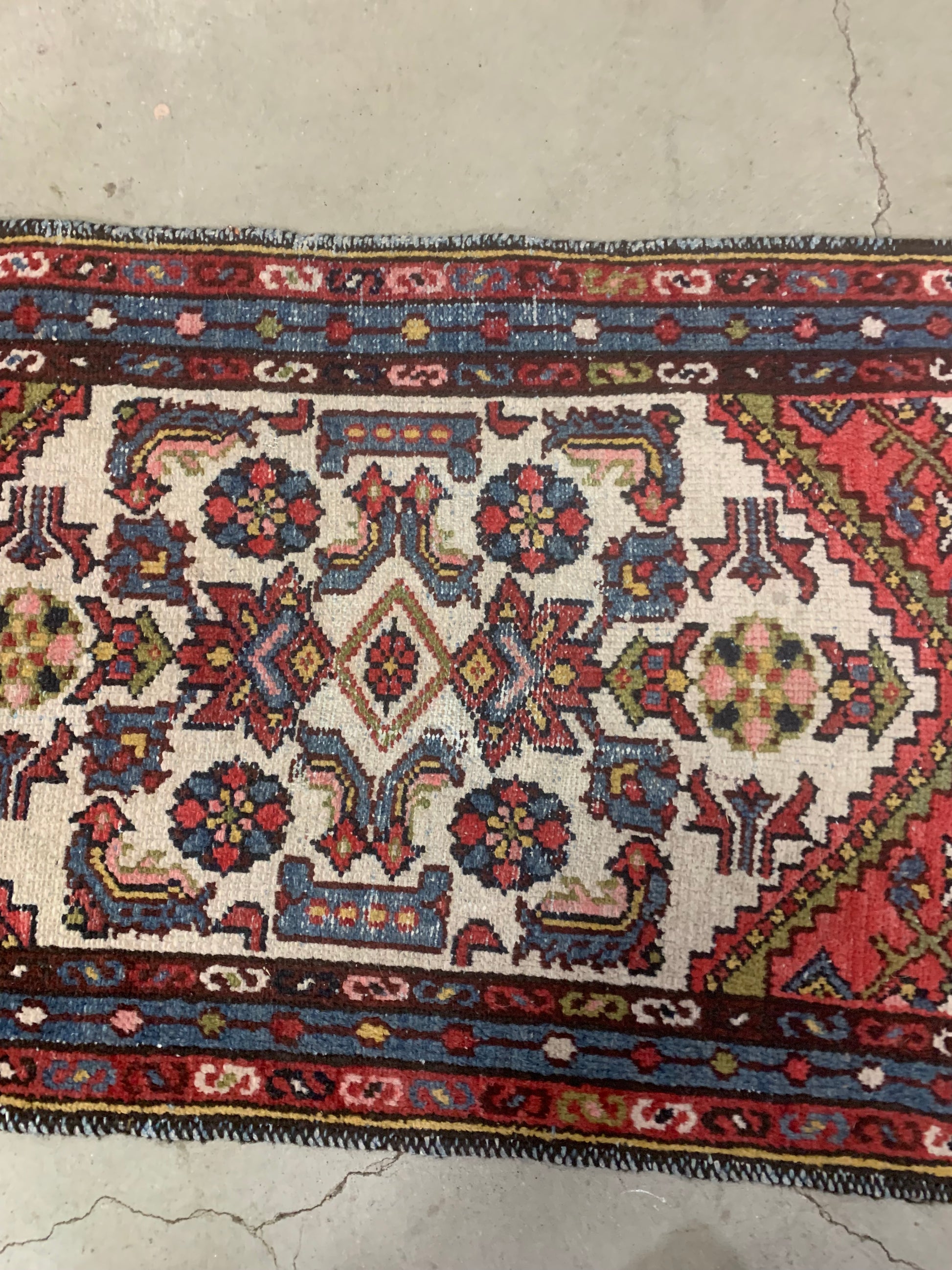 Symmetric central medallion on an antique Persian rug.
