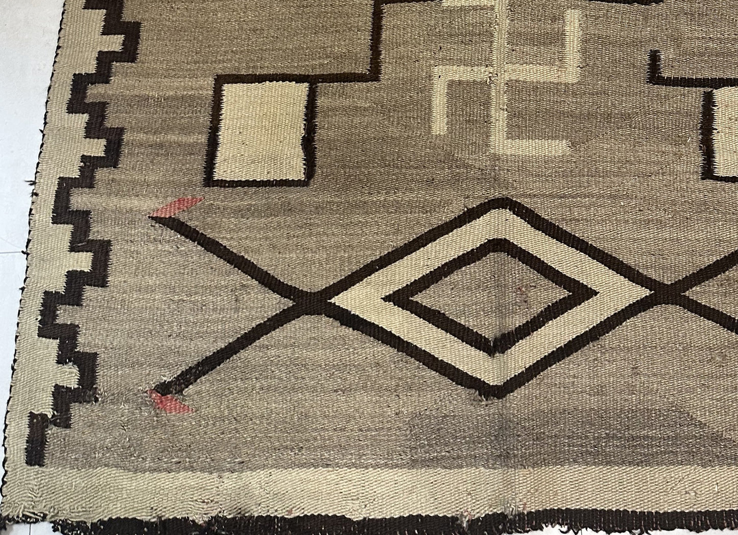 Detail of the natural wool texture and the rich, earthy color palette.

