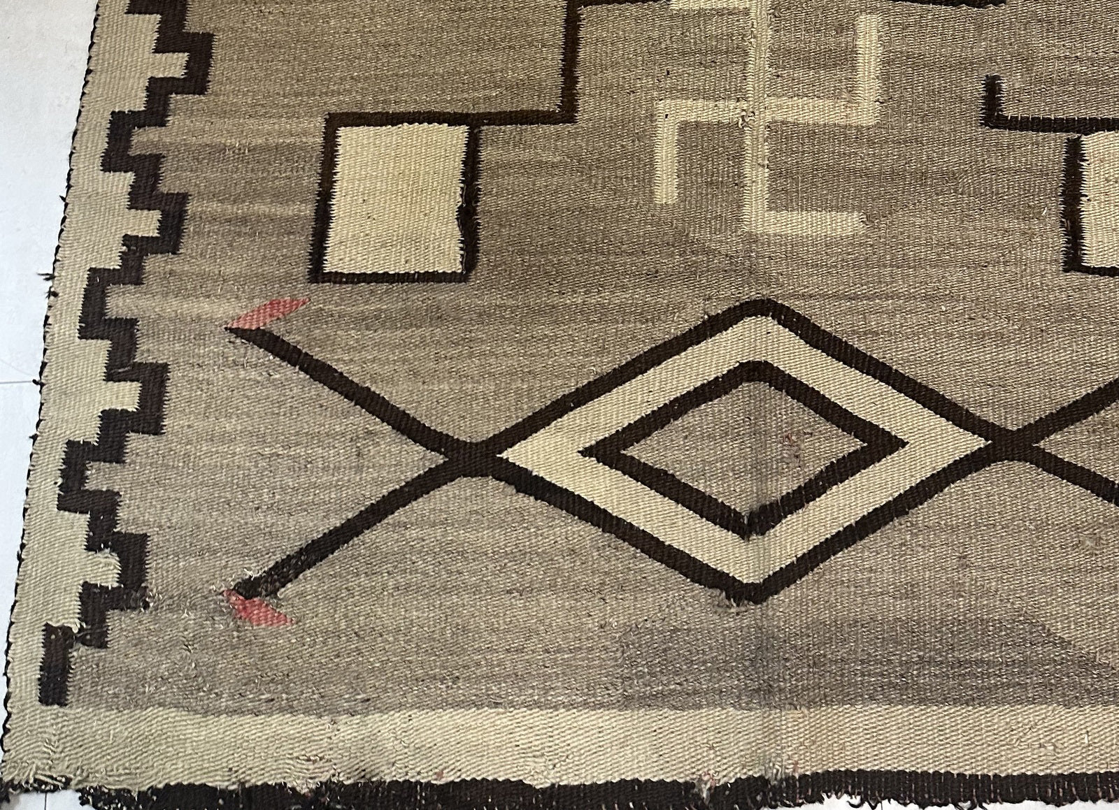 Detail of the natural wool texture and the rich, earthy color palette.

