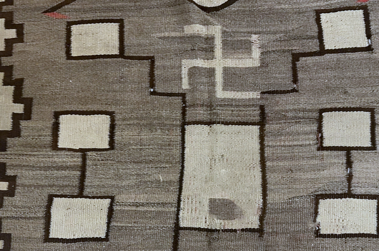 Angle shot capturing the bold contrast between the black motifs and neutral field.

