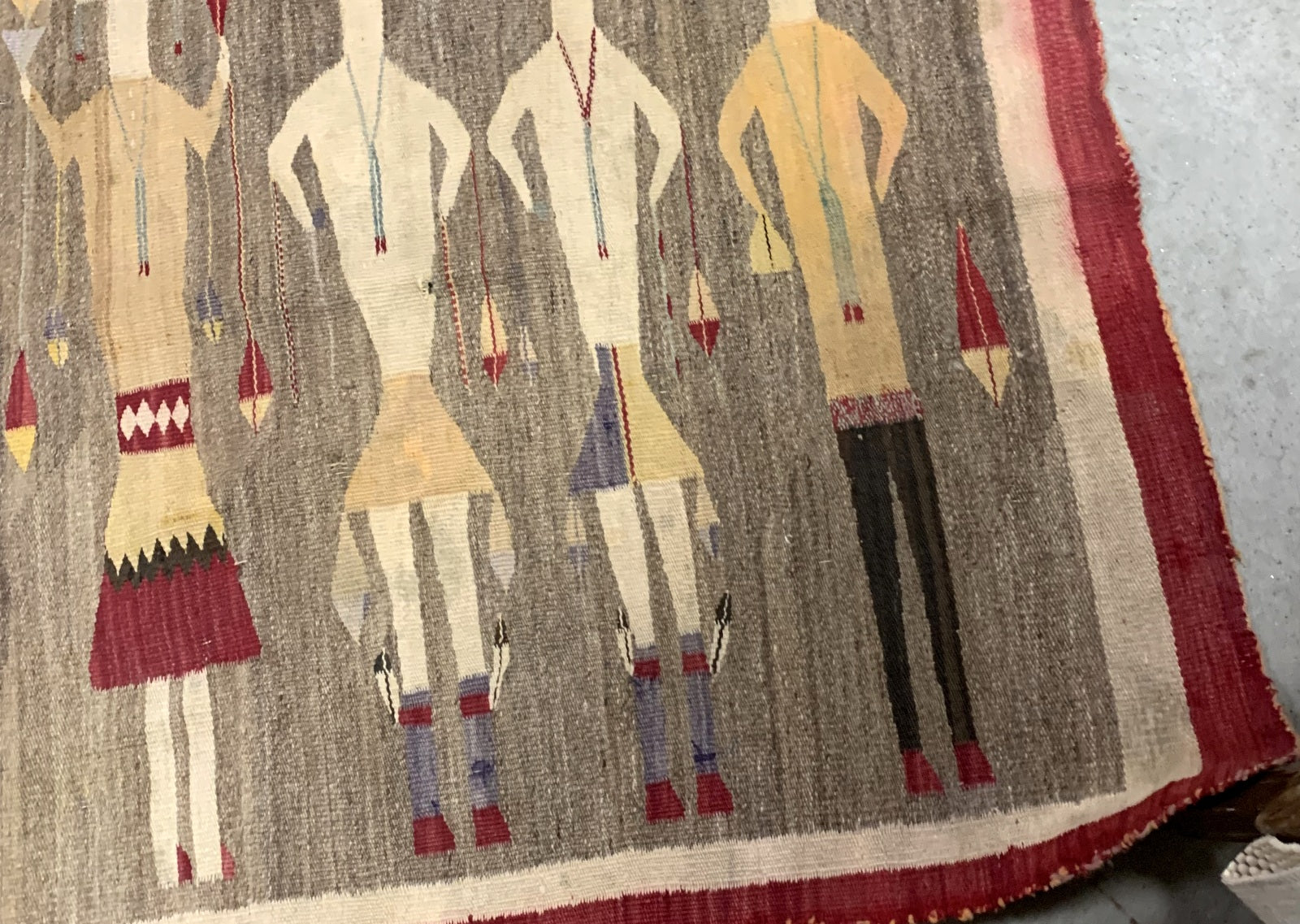 Symbolic Yei figures on a handmade Navajo rug, 3.4' x 5.11'
