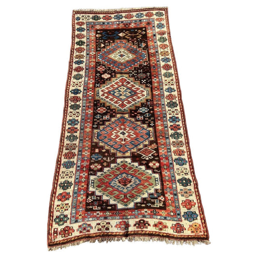 Full view antique Kazak rug 104×195 cm with three medallions