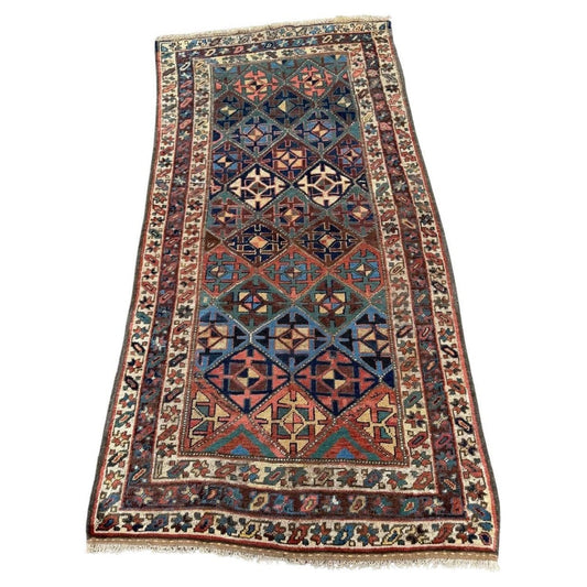 Full view antique Kurdish rug with green, blue, red tribal motifs