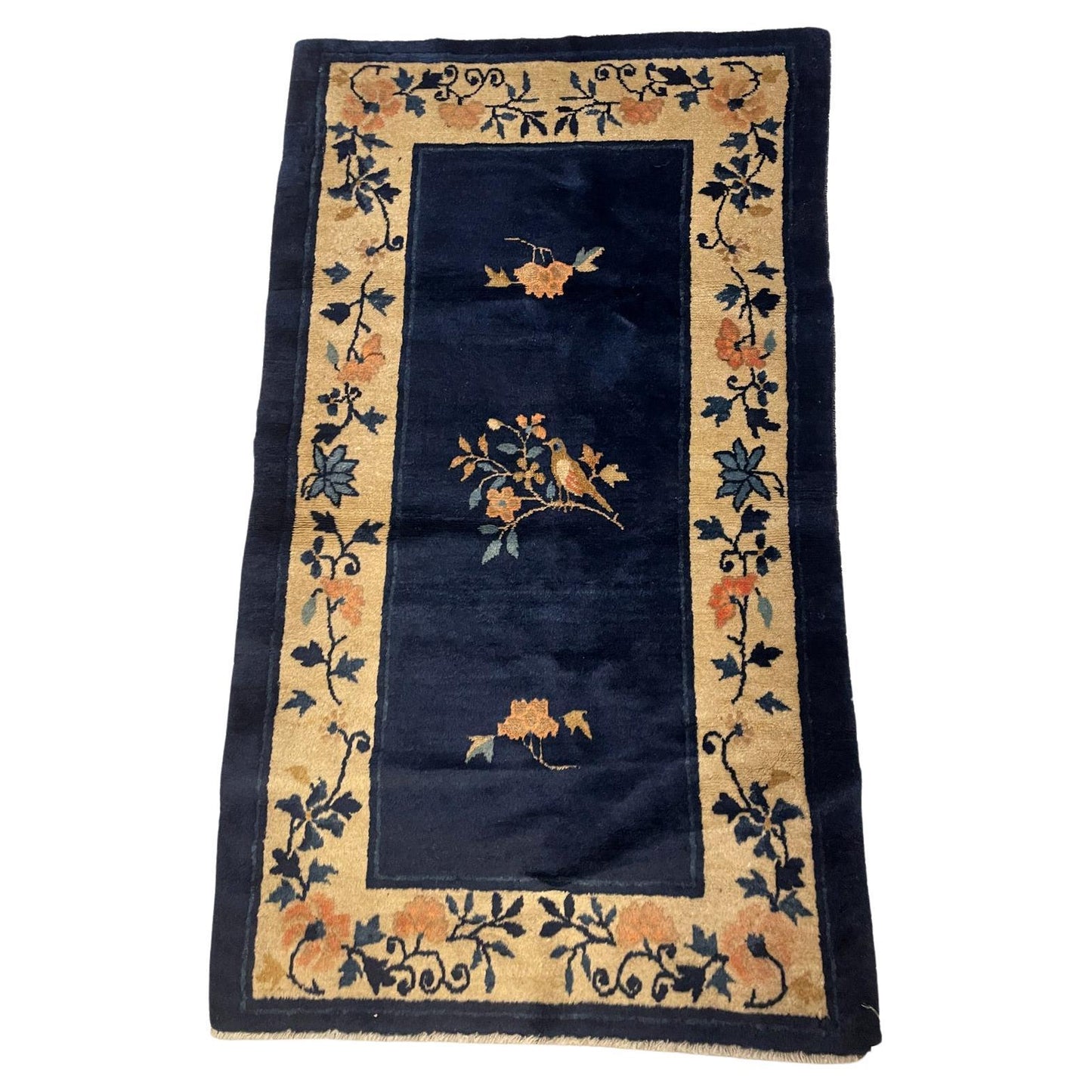 Antique Chinese Peking rug with a deep indigo blue field.

