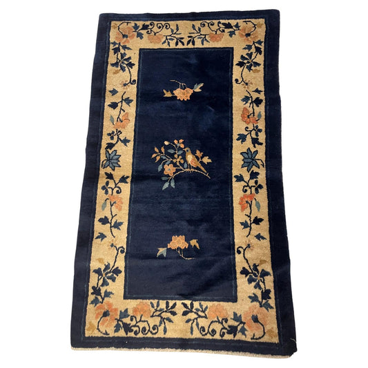 Antique Chinese Peking rug with a deep indigo blue field.

