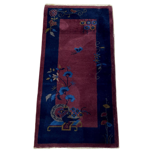 Antique Chinese Art Deco rug with a deep aubergine field.

