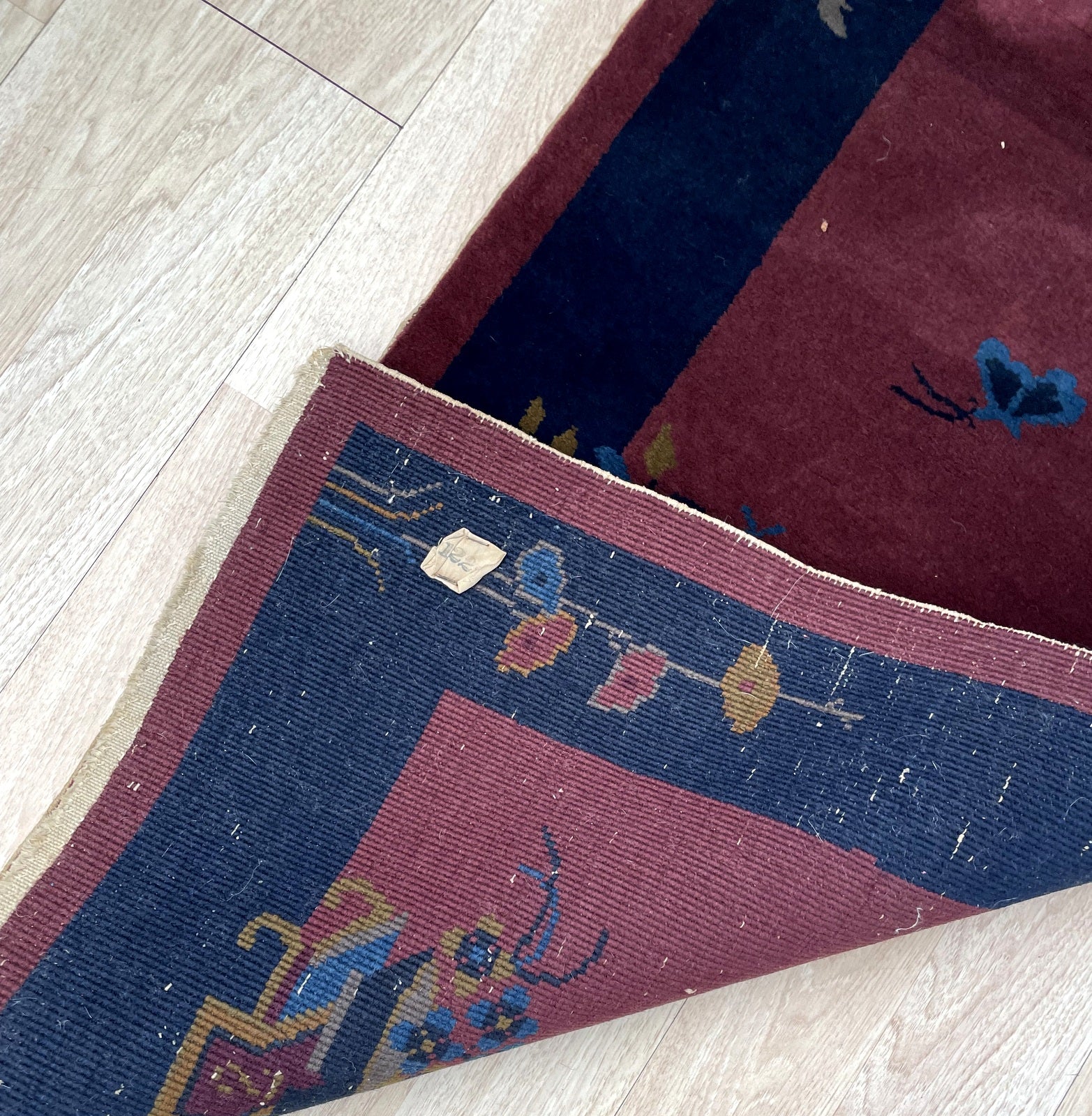 Textured hand-knotted wool pile of the vintage rug.

