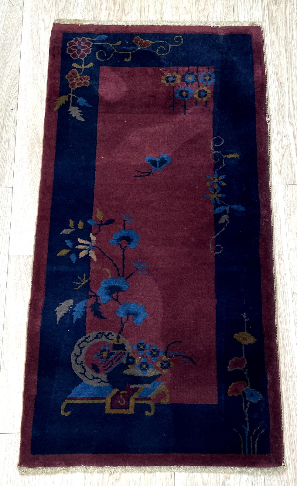 Textured hand-knotted wool pile showing excellent condition.

