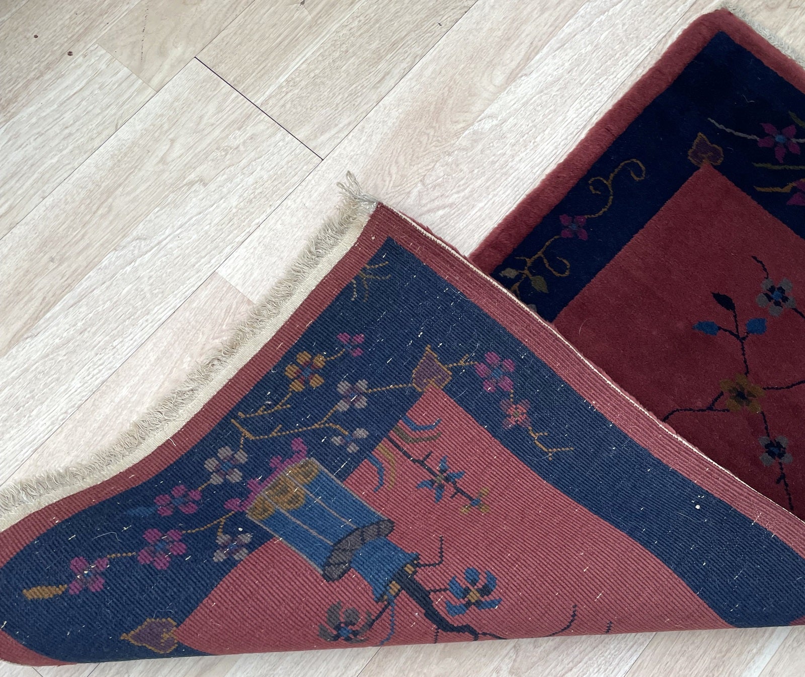 Detailed view of the decorative vase base in teal and blue.

