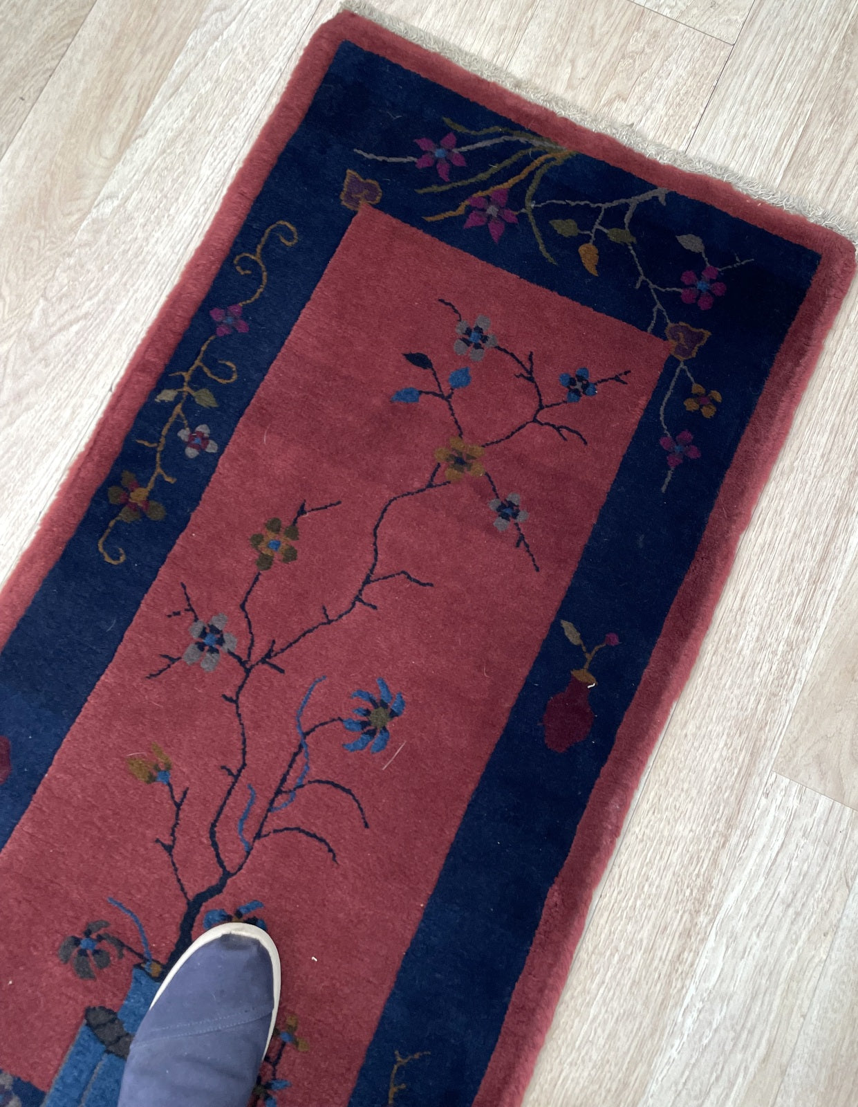 Full view of the rug showcasing the complete tree and vase design.

