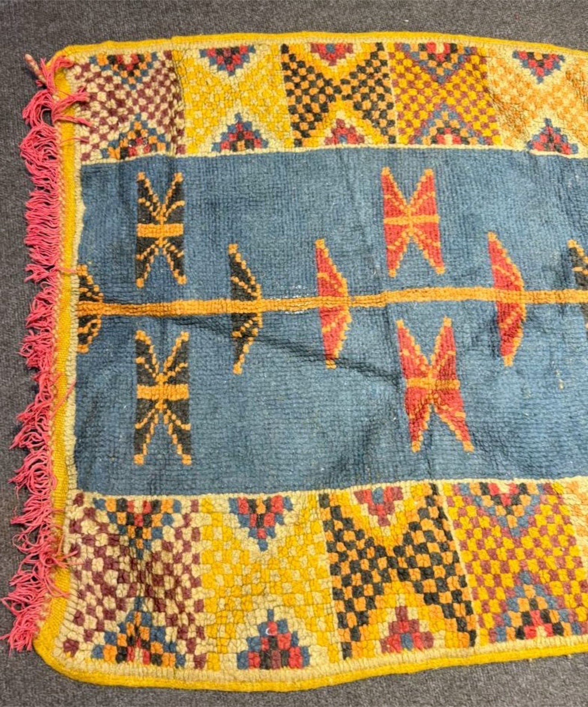 Textured hand-knotted wool pile showing thick tribal construction.

