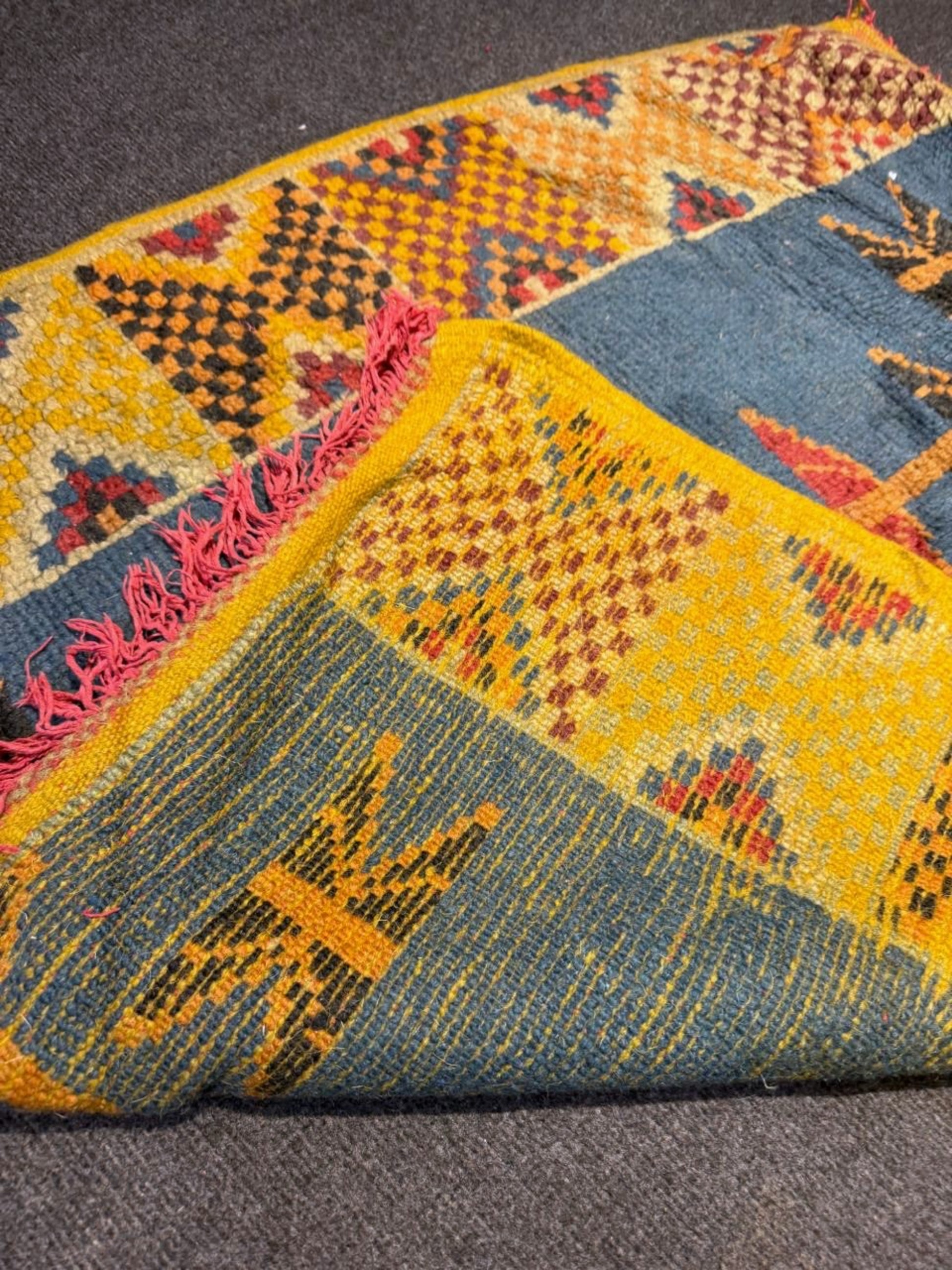 Contrast between the teal blue center and vibrant yellow frame.

