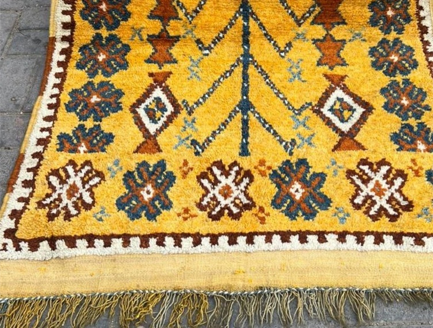 Detailed view of geometric tribal symbols in teal and brown.

