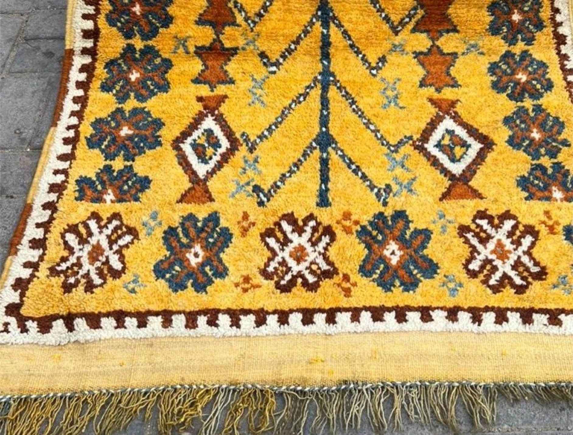 Detailed view of geometric tribal symbols in teal and brown.

