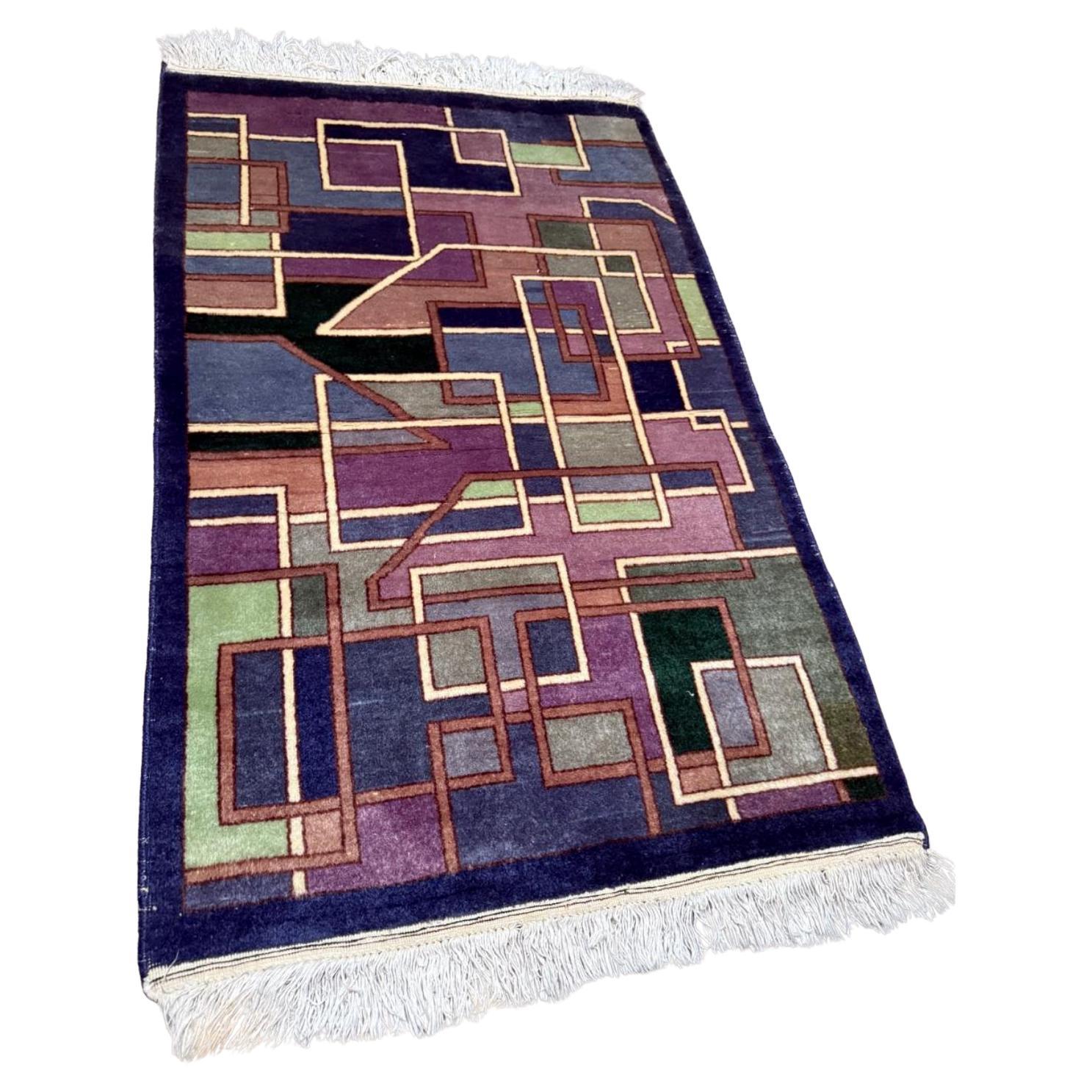 Vintage Chinese Art Deco rug with an abstract geometric pattern.

