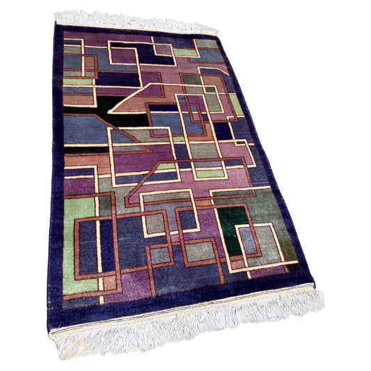 Vintage Chinese Art Deco rug with an abstract geometric pattern.

