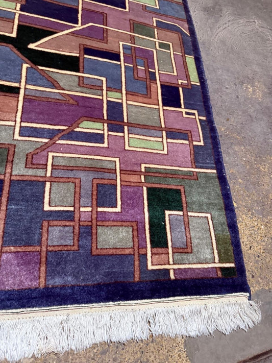 Close-up of interlocking rectangles and squares in indigo blue.

