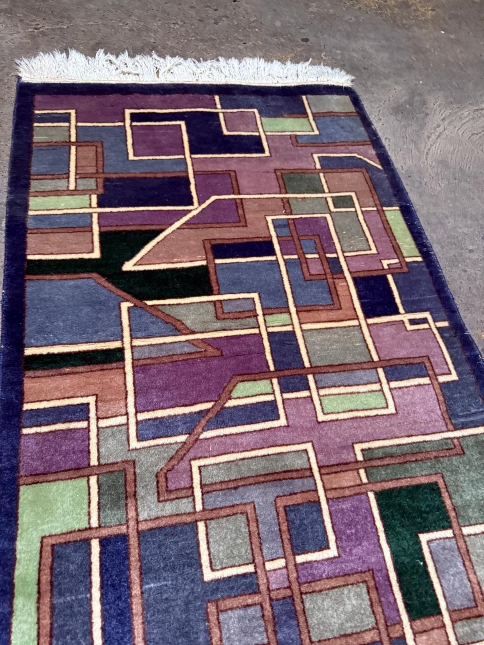 Detailed view of overlapping geometric forms in plum and purple.

