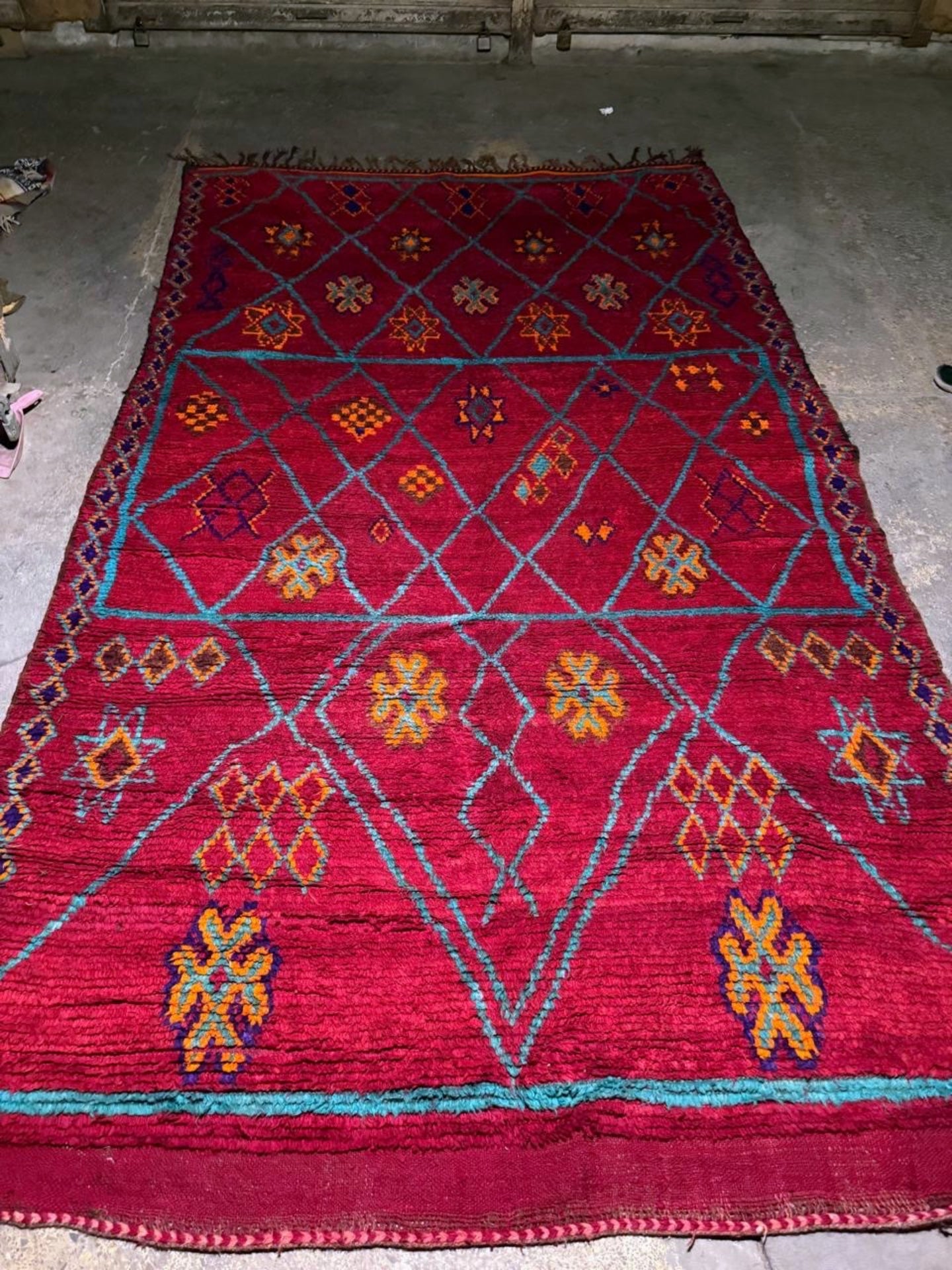 Teal blue lines creating diamond framework on red background

