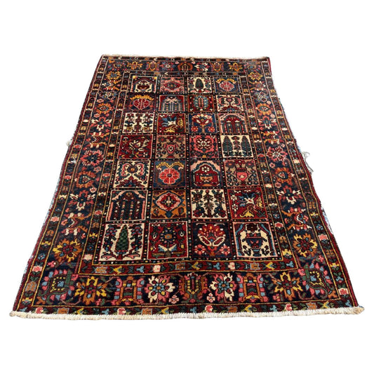 Full top view of the antique Persian Bakhtiari rug showing the complete garden panel design.

