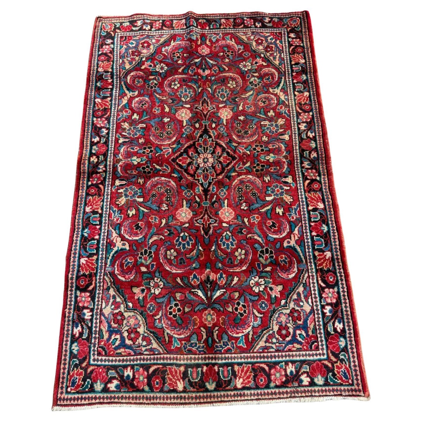 Full top view of the antique Persian Sarouk rug showing the complete all-over floral pattern.

