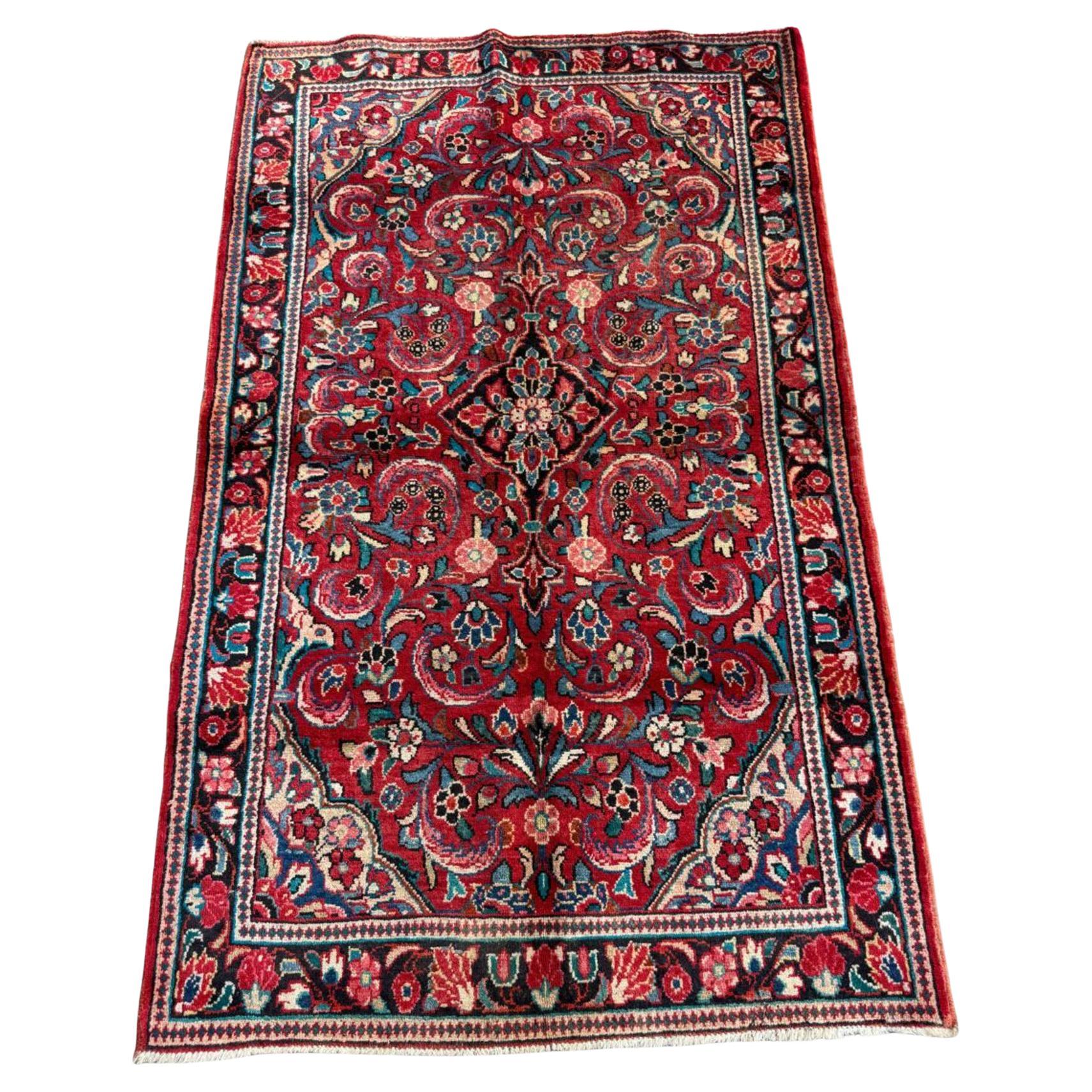 Full top view of the antique Persian Sarouk rug showing the complete all-over floral pattern.

