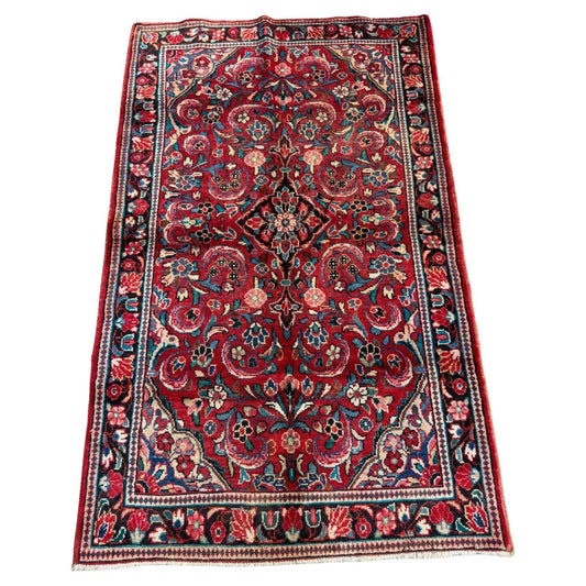 Full top view of the antique Persian Sarouk rug showing the complete all-over floral pattern.

