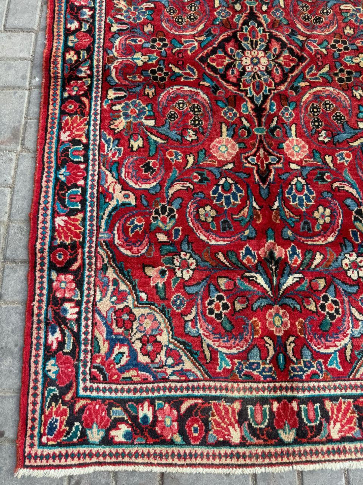 Detail of the signature velvety deep red or cranberry background color.

