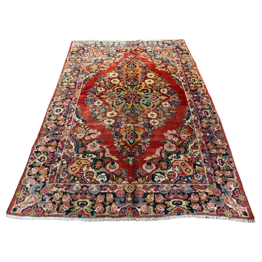 Full top view of the antique Persian Sarouk rug showing the large central medallion.

