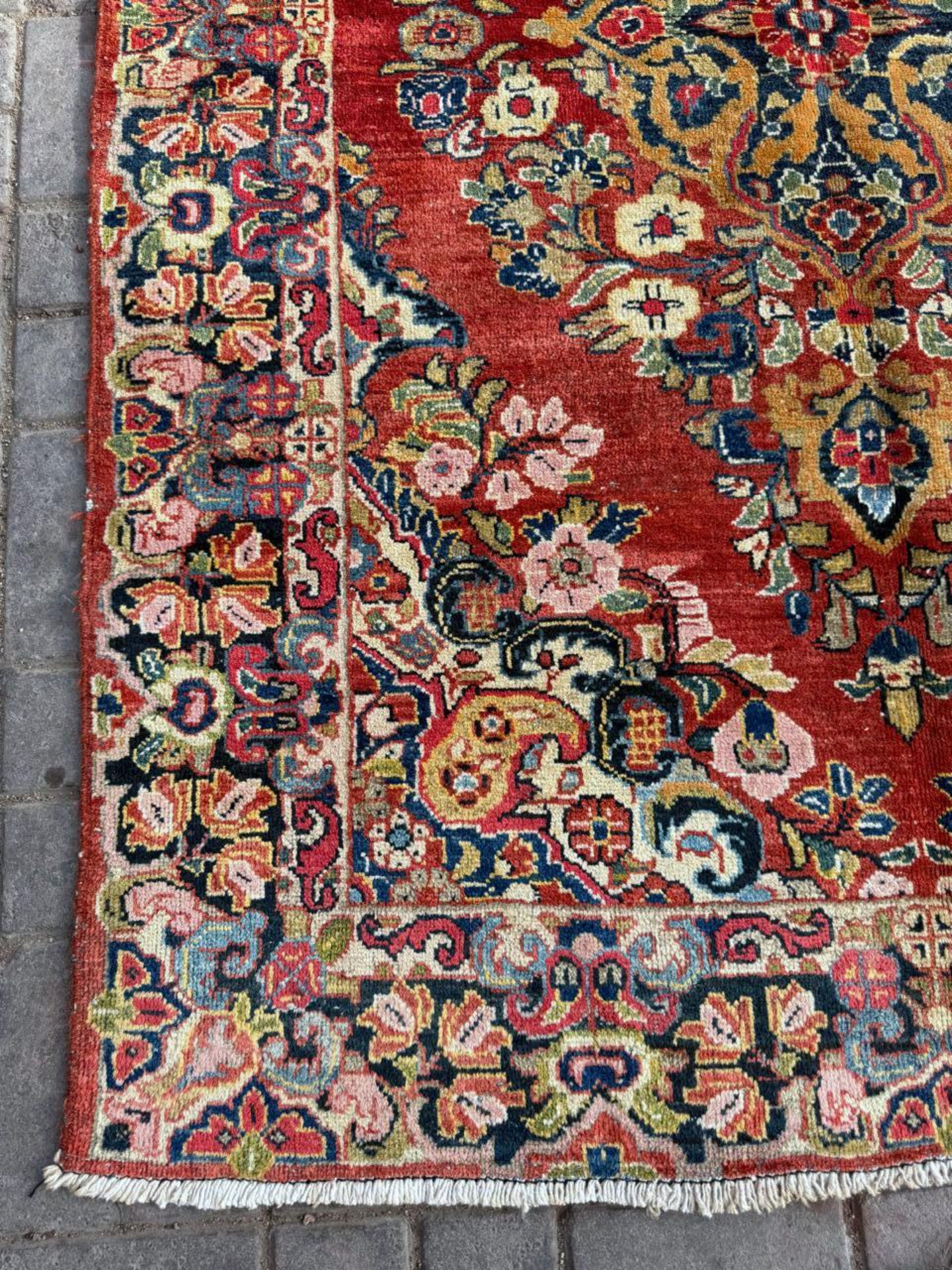 Detail of the rich terracotta red background color.

