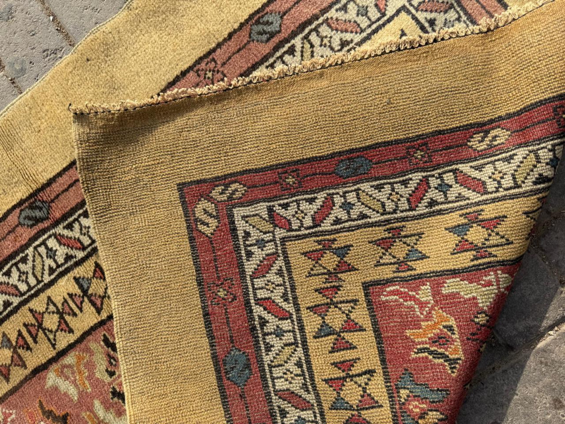 Tribal geometric medallions on deep red-brown field

