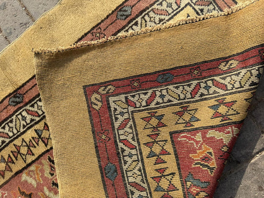 Tribal geometric medallions on deep red-brown field


