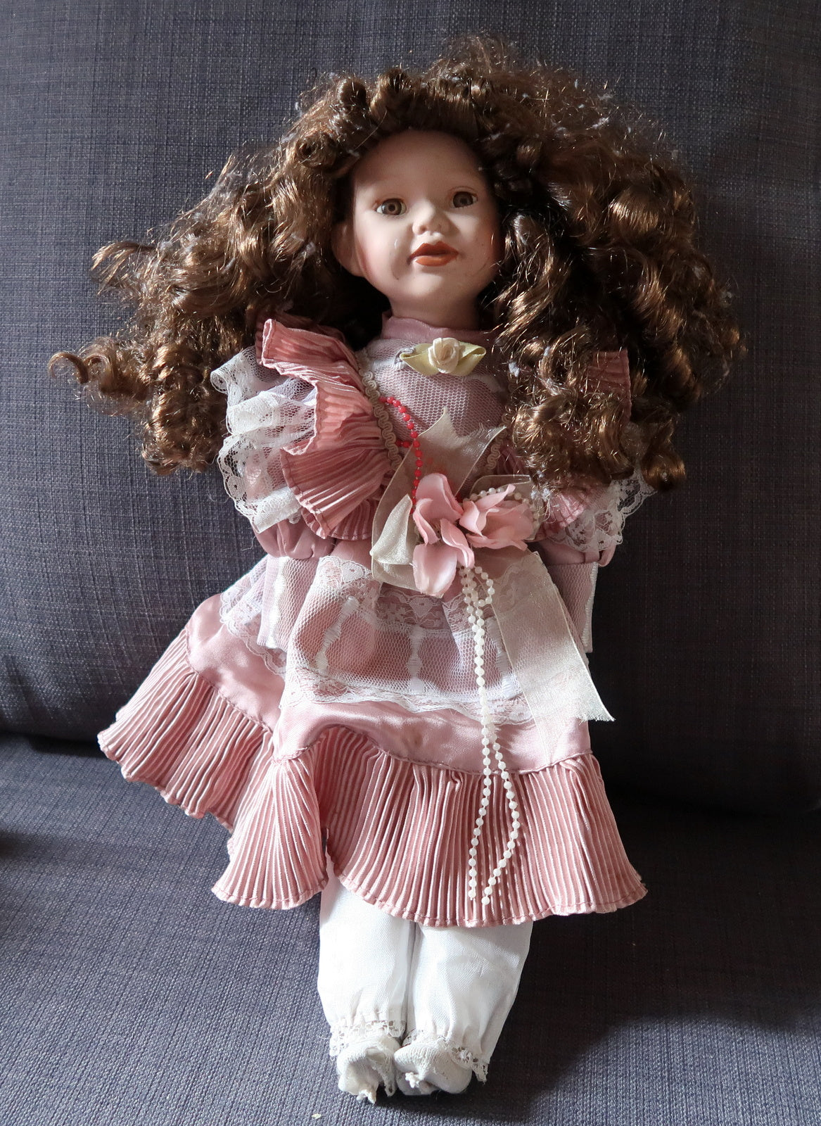Elegant pink porcelain doll capturing vintage beauty
