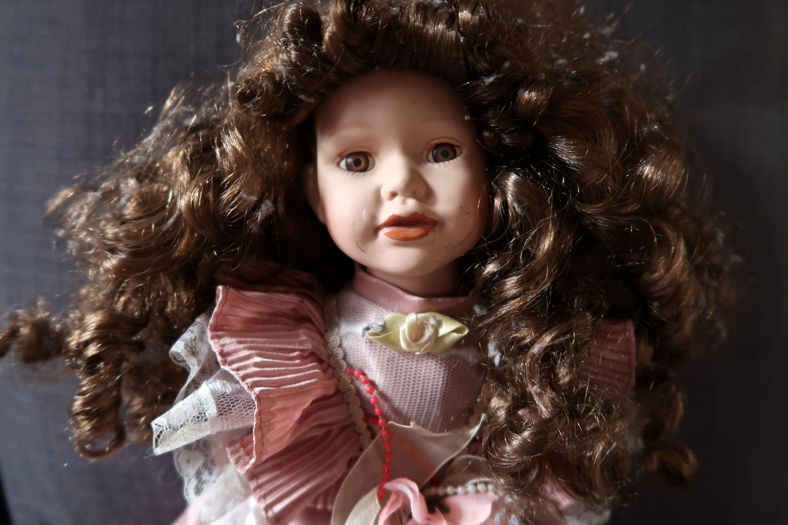 Charming collectible porcelain doll with expressive facial features
