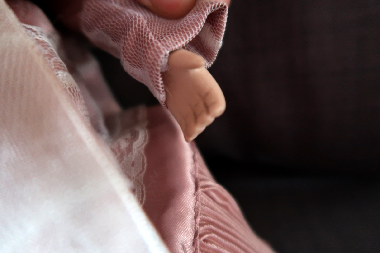 Classic 20th-century porcelain doll with charming pink attire
