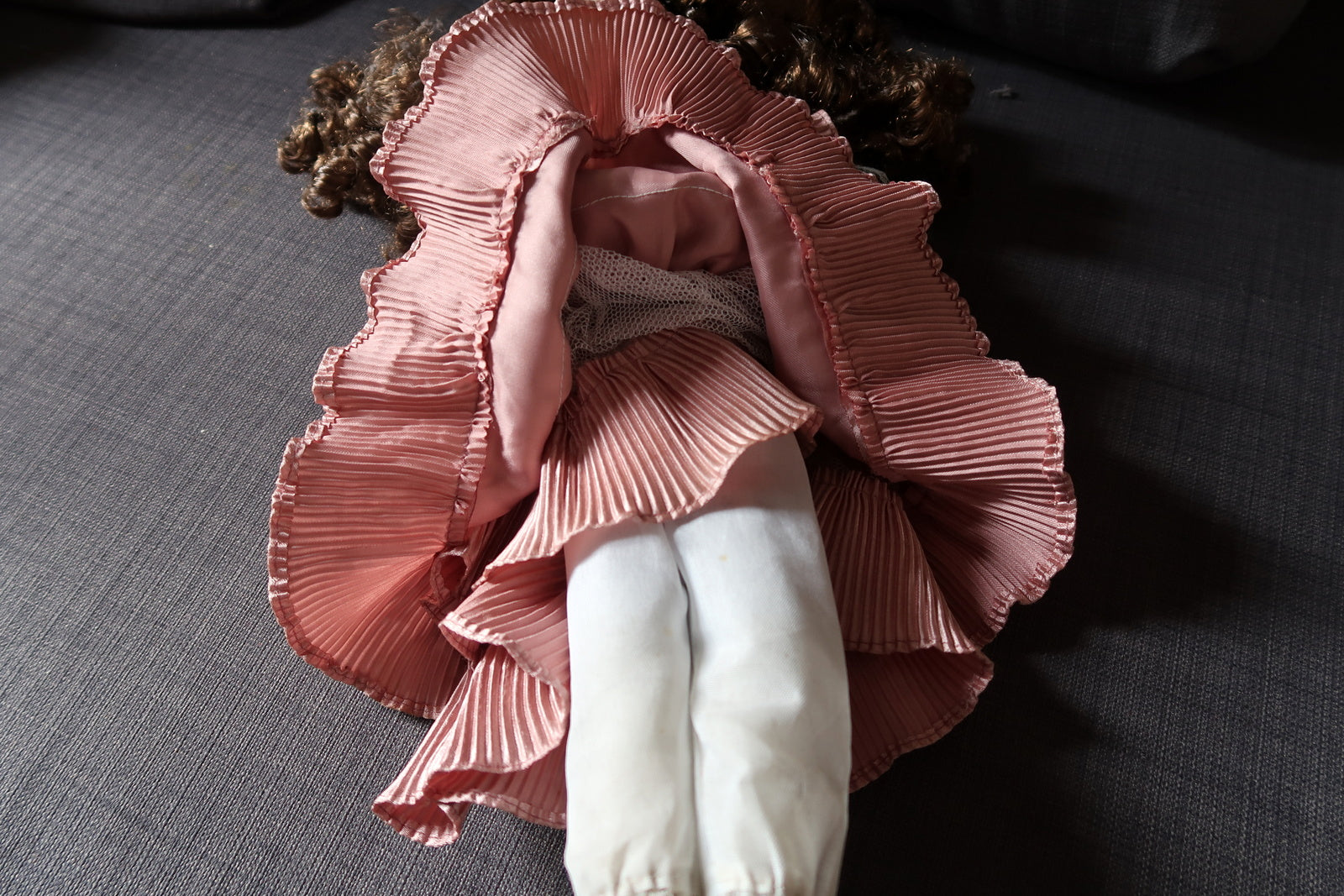 Antique-inspired porcelain doll with intricate clothing details
