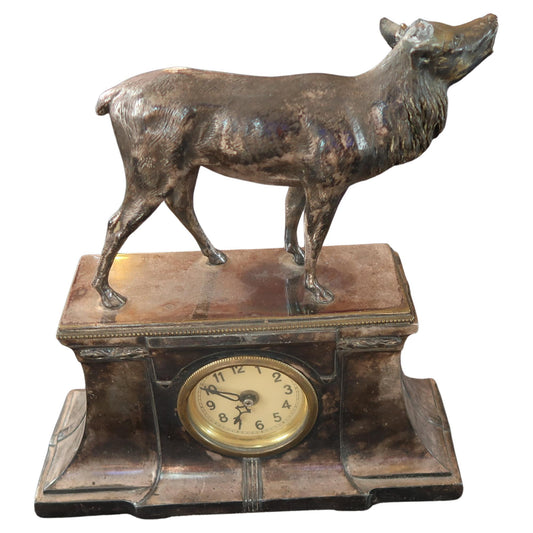 Front view of antique metal deer clock showing full sculpture and clock face

