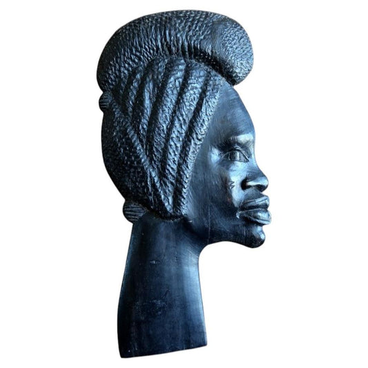 African ebonized hardwood wall plaque featuring a hand-carved female portrait inspired by Makonde tribal art aesthetics.