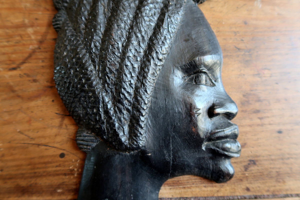 Natural raw unpolished timber texture and original woodworking marks on the back of a hand-carved African hardwood relief.