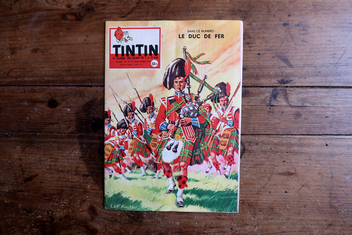 Vintage Tintin comic book cover on a wooden surface