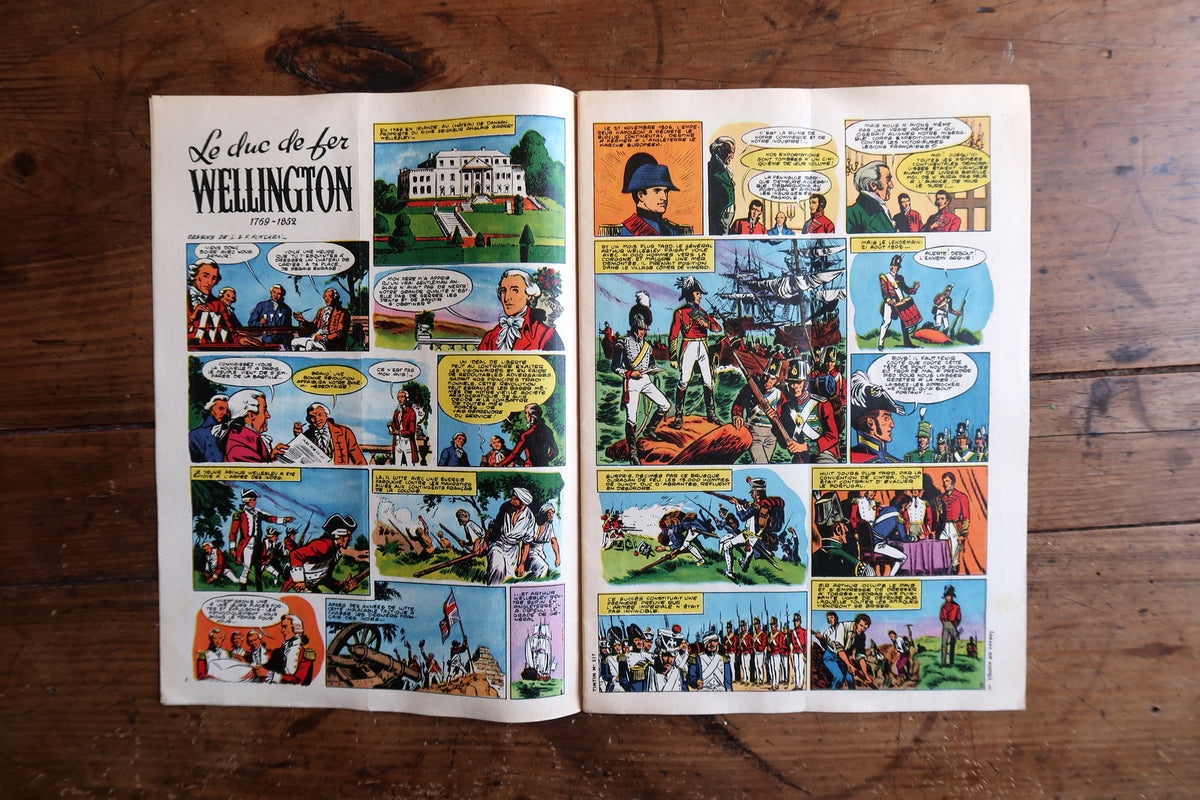 Open comic book with illustrations on a wooden surface