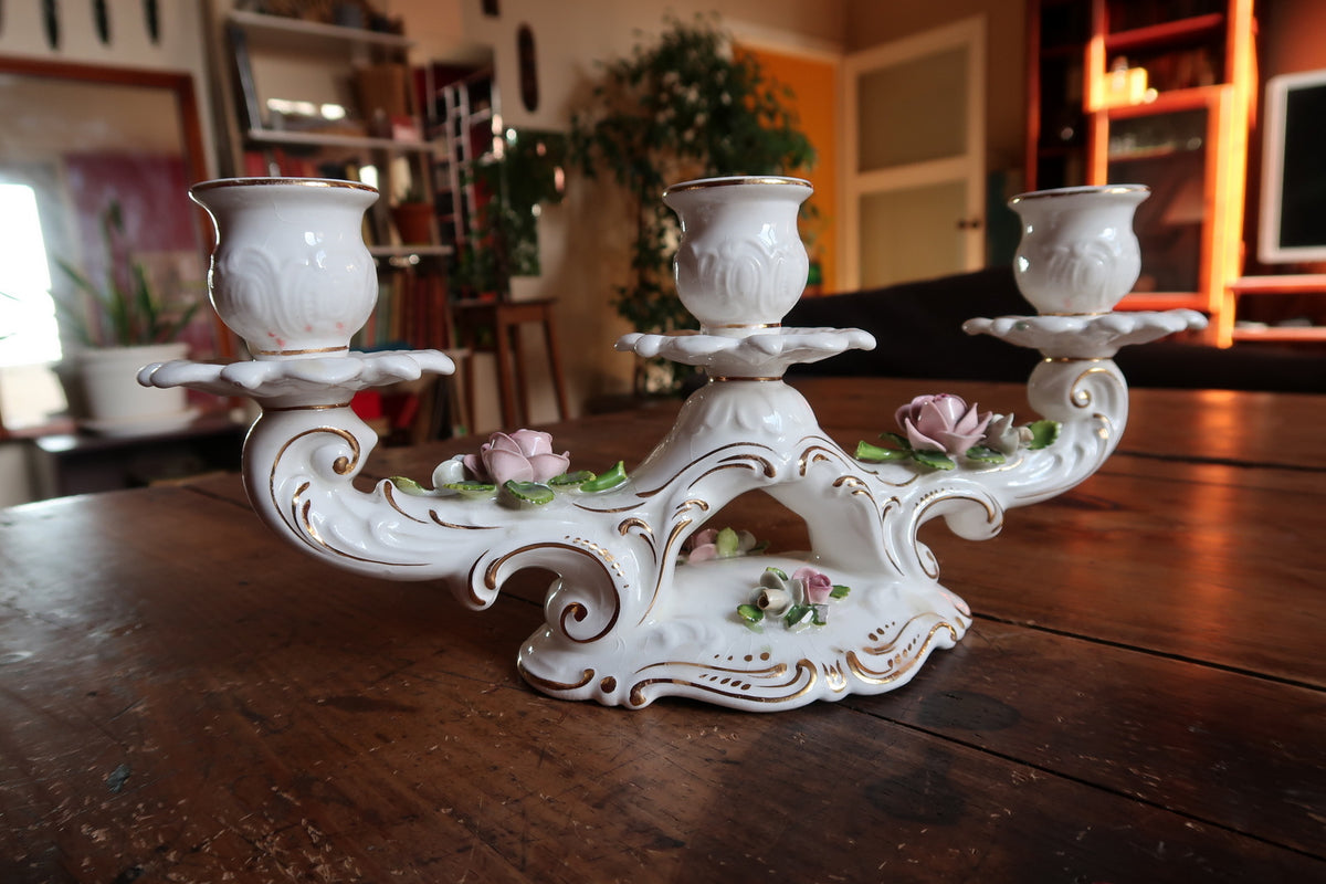 Elegant Schumann Arzberg white porcelain candelabra adorned with pink floral rose clusters and heavy gold gilding.