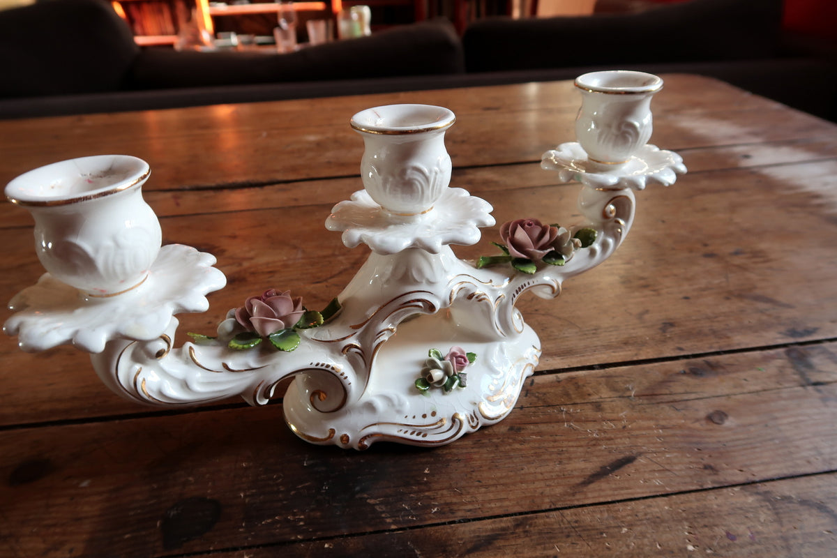 Detailed porcelain candle sconce sockets with gold rim detailing on a vintage Schumann Arzberg German candle holder.
