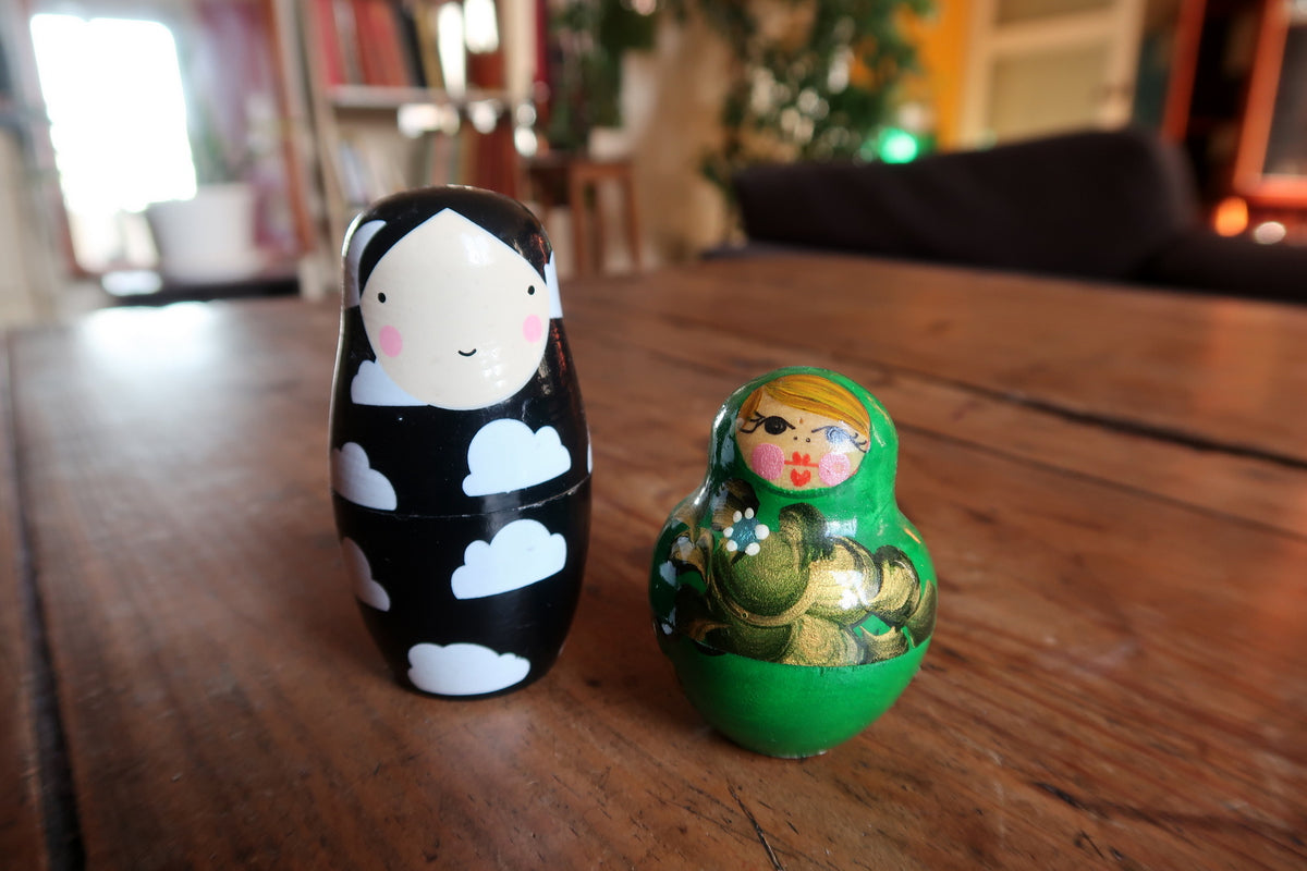 Contemporary stylized black Matryoshka nesting doll with gold and silver accents on turned timber body.