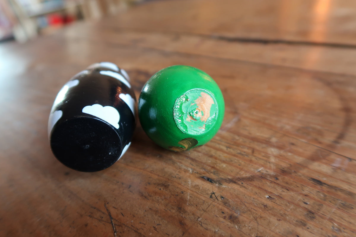 Intricate hand-painted lacquered finish showcasing fine brushwork detail across wooden Russian folk art nesting dolls.